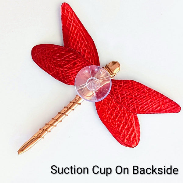 Red and copper dragon fly with suction up