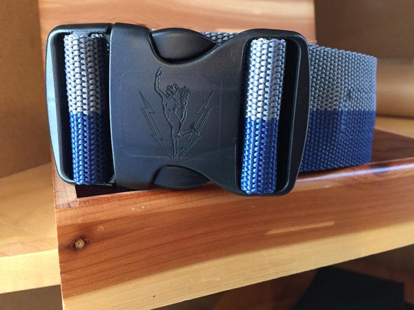 Close up of the black C&E engraved belt buckle featuring Mercury (Jimmy) with lightning bolts. The buckle is attached to the cloth grey and blue belt.