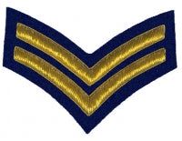 Gold embroidered corporal rank on blue background.