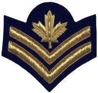 Gold embroidered master corporal rank on blue background.