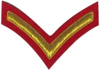 Gold embroidered private rank on red background.