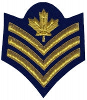 Gold embroidered sergeant rank on blue background.