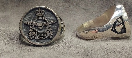 Silver ring with the Air Force crest. a second ring shows the Maple Leaf on the shoulder.