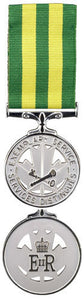 Front and back face of the Corrections Exemplary Service Medal, also shown is the green and yellow ribbon.