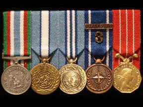 Rack of five mini medals.