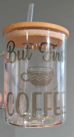 Clear tumbler with wooden lid and straw, featuring 'But First Coffee' text and a coffee cup illustration.