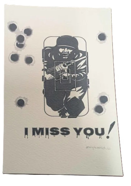 Notebook with a black and white illustration of a soldier with a gun text 'I MISS YOU!' on a beige background.