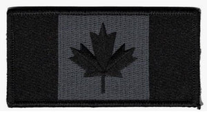 Black and gray Canadian flag patch on a black background