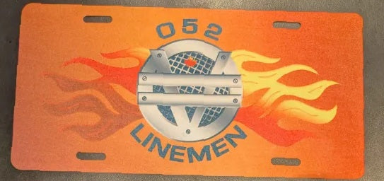 License plate with ' 052 LINEMEN' and flame design on an orange background