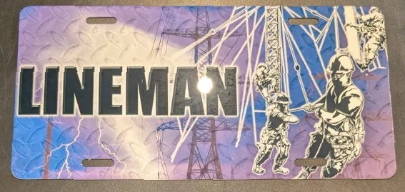 License plate with 'LINEMAN' text and images of workers on a power line tower.