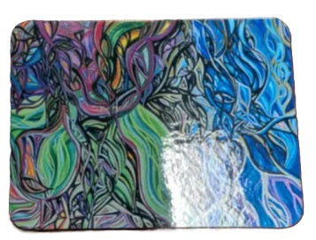 A rectangular mat with rounded corners featuring a vibrant, abstract tree design. The artwork is split vertically, with the left side showing green, purple, and blue swirling branches and the right side showing blue branches with white highlights, set against a plain white background.