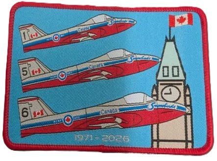 A rectangular embroidered patch with a red border on a light blue background, featuring RCAF Snowbirds, flying by the Peace Tower. The text '1971 - 2026' is printed along the bottom.