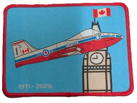 A rectangular embroidered patch with a red border on a light blue background, featuring a single RCAF Snowbird, flying by the Peace Tower. The text '1971 - 2026' is printed along the bottom.