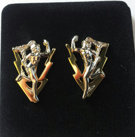 Close-up of a pair of C&E with lightning bolt collar dogs. The lightning bolts are gold and the Mercury (Jimmy) is silver.