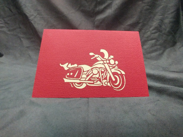 Red card featuring cut-out of a motorcycle