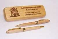 Maple wood pen case with pen and pencil.