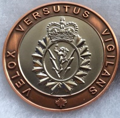 Back side of the Branch coin with a bronze rim and silver center which has the C&E crest. Text reads "Velox Versutus Vigilans"