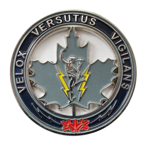 Division coin back with text "Velox Versutus Vigilans" surrounding light blue leaf with mercury in the center. The outer rim is dark blue and has red maple leafs at the bottom.