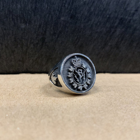 Silve ring with the C&E Crest on the face and a maple leaf on the shoulder.