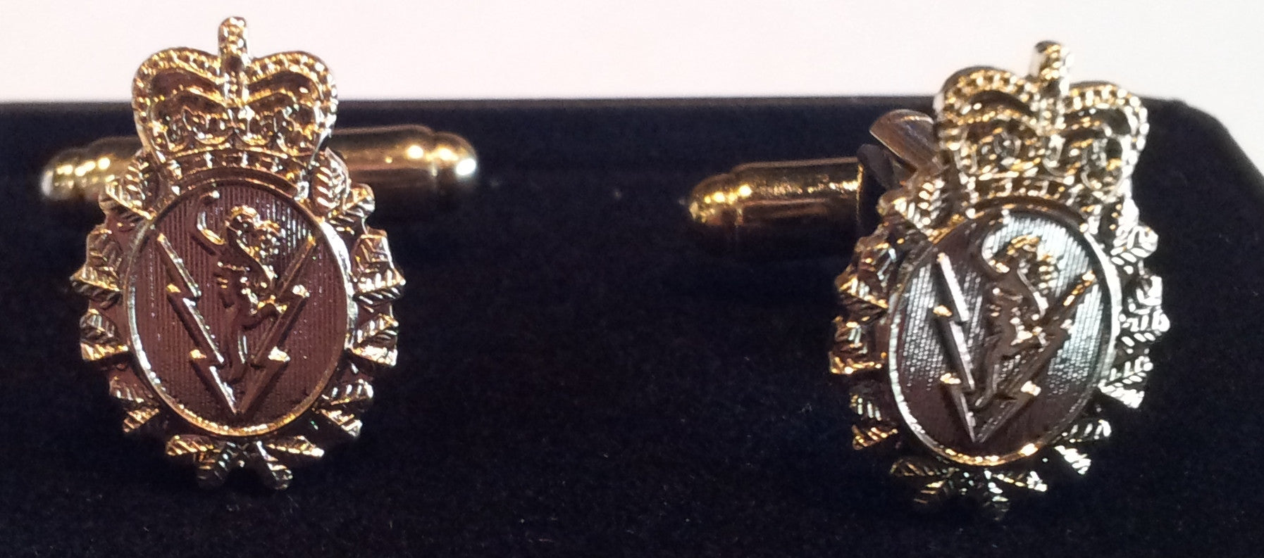 Gold cufflinks with the C&E crest.