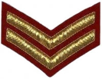 Gold embroidered corporal rank on red background.