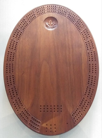 Front face of wood creibboard, has maple leaf ingrained toward the top, The area below the leaf is engravable