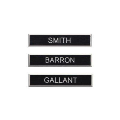 Three examples of black plastic DEU name tags. The names on the tags are Smith, Barron, and Gallant.