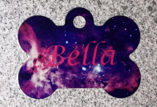 Bone shapped tag with galaxy style background and "Bella"