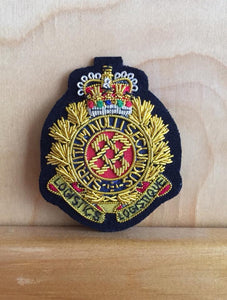 Embroidered cloth logistics officers cap badge.