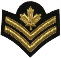 Gold embroidered master corporal rank on black background.