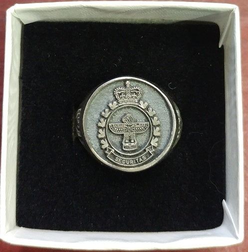 Silver ring with the Military Police Crest on it. 