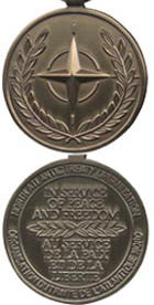 Front and back face of broze Nato medal.