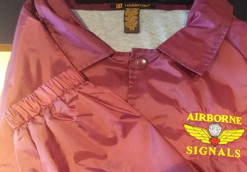 Close-up of Maroon jacket with embroidered Ariborn signals in yellow and jump wings with red maple leaf.