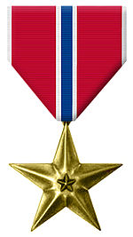 Front face of the bronze star, also featured is the white, red and blue ribbon.