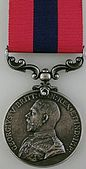 Front face of the of the silver Distinguished Conduct Medal featuring King George V.