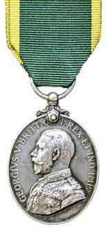 Front face of the silver Efficiency medal deaturing King George V.
