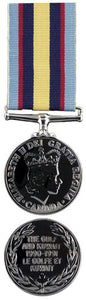 Front and back face of the silver Gulf and Kuwait Medal, also shown is the light blue, red, dark blue, and yellow ribbon.