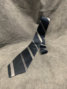 Tie with blue and grey C&E pattern.