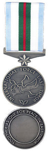 Silver front and back face of the International Force East Timor medal with blue, white, green and red ribbon.