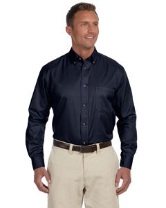 Man wearing long sleever navy collared shirt and white pants.