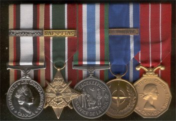 Rack of mounted medals feauturing SWASM with Afghanistan bar, GCS-SWA with ISAF bar, CPSM, Nato-FY with Former Yugoslavia bar, and CD.