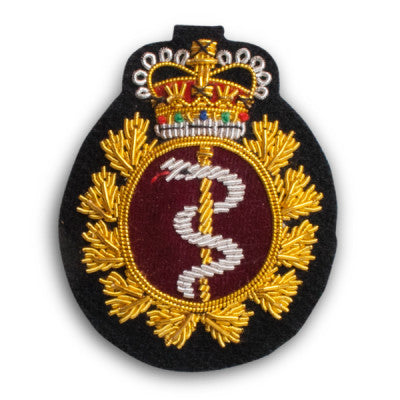 Cloth hat badge with medical crest with silver snake.