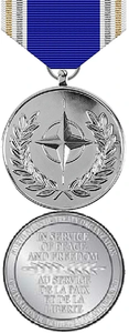Front and back face of the silver Nato Meritorious Medal, also shown is the white, gold, silver, and blue ribbon.