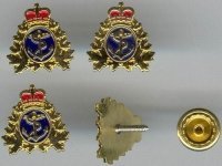 Set of four gold shirt studs with the navy crest. One of the studs is turned around to showcase the back and how they attach.