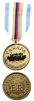 Front and back face of the gold somalia medal, also featured is the light blue, white, tan, dark blue and red ribbon.